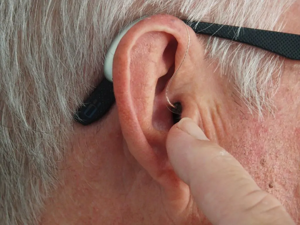 Hearing aid in an old man