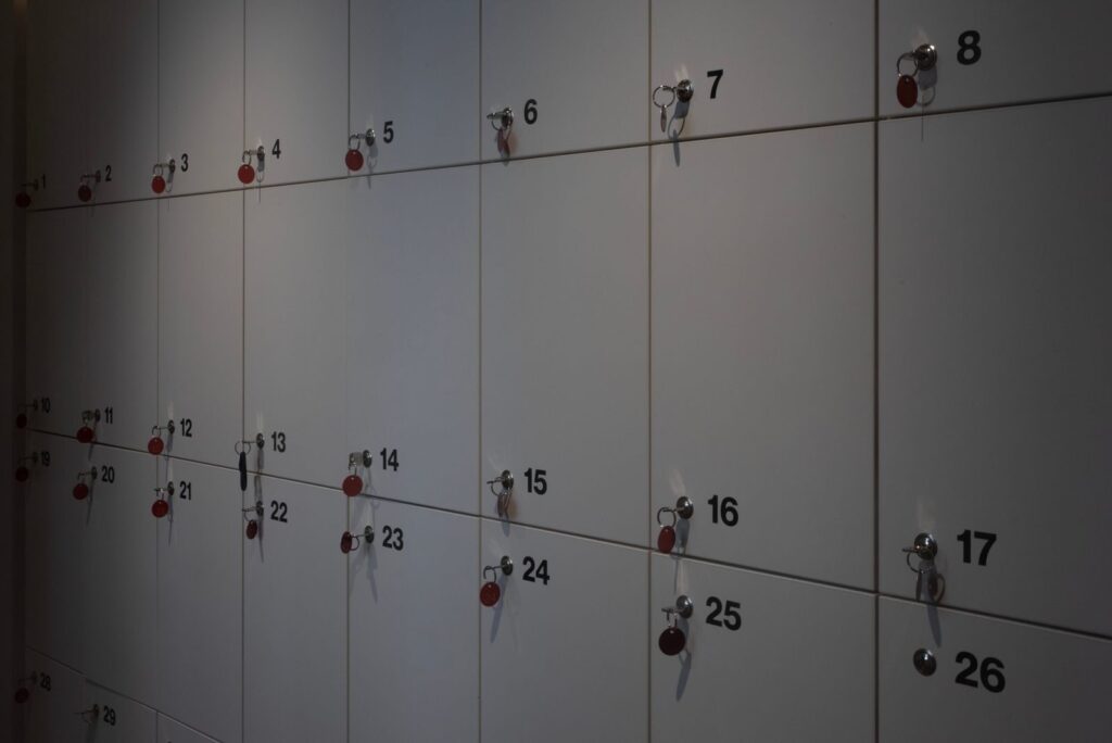 Row of numbered lockers with keys in the doors