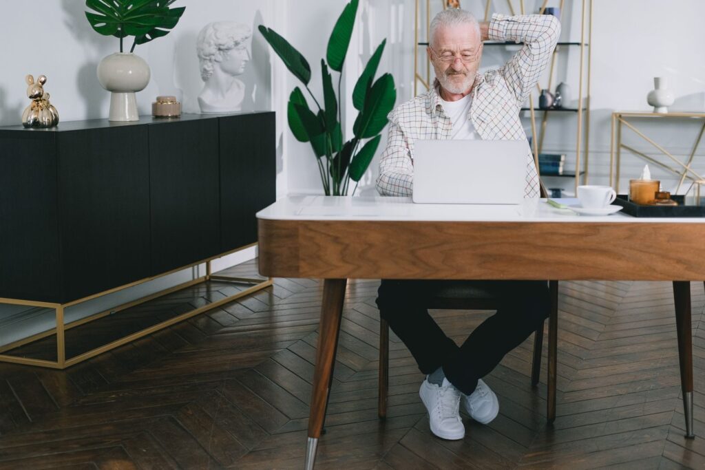 Man at a laptop at a desk at home, a place where you could install Docker on Ubuntu