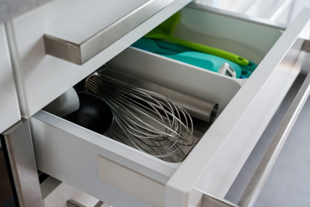 Open kitchen drawer with neatly sorted utensils