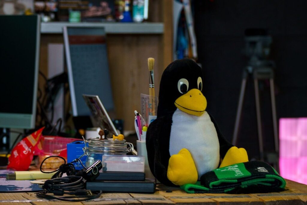 Desk with a Tux penguin figure, the Linux mascot, in this Tailscale Ubuntu setup guide