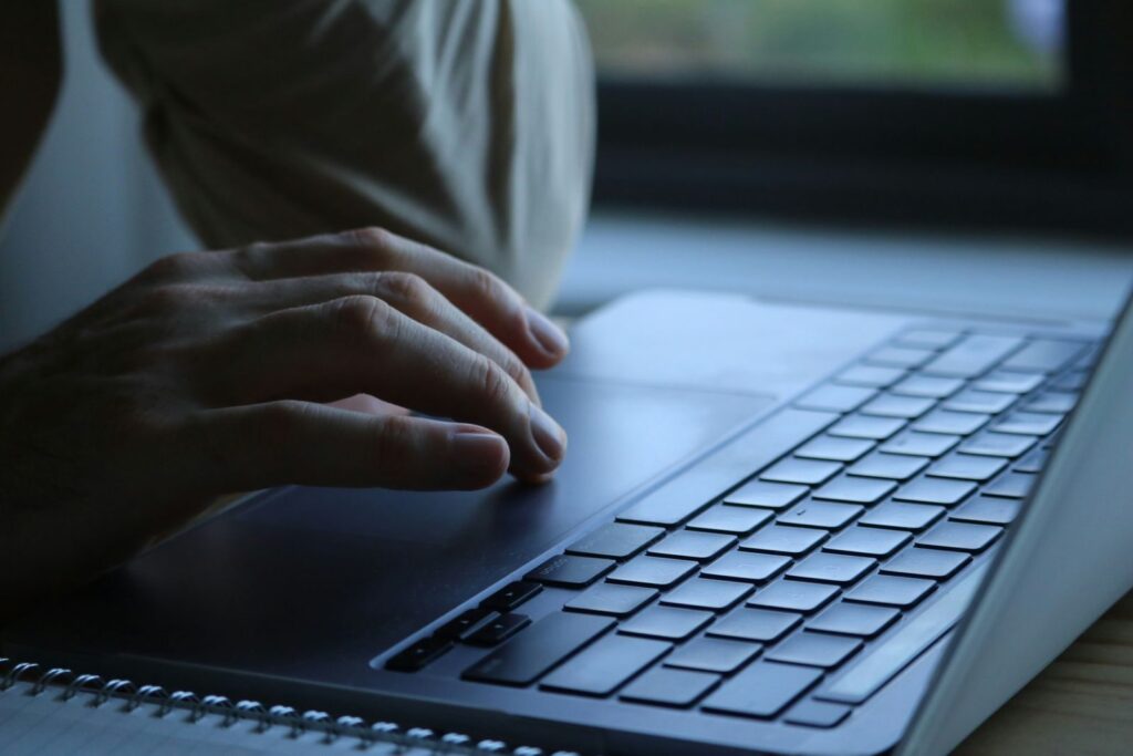 Patch Tuesday October 2026: close-up of hands typing on a laptop keyboard at home