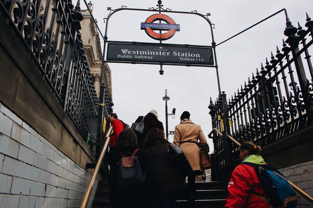 People walking down steps into Westminster Underground station