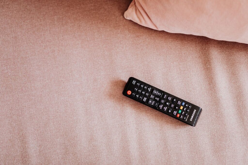 TV remote resting on a sofa
