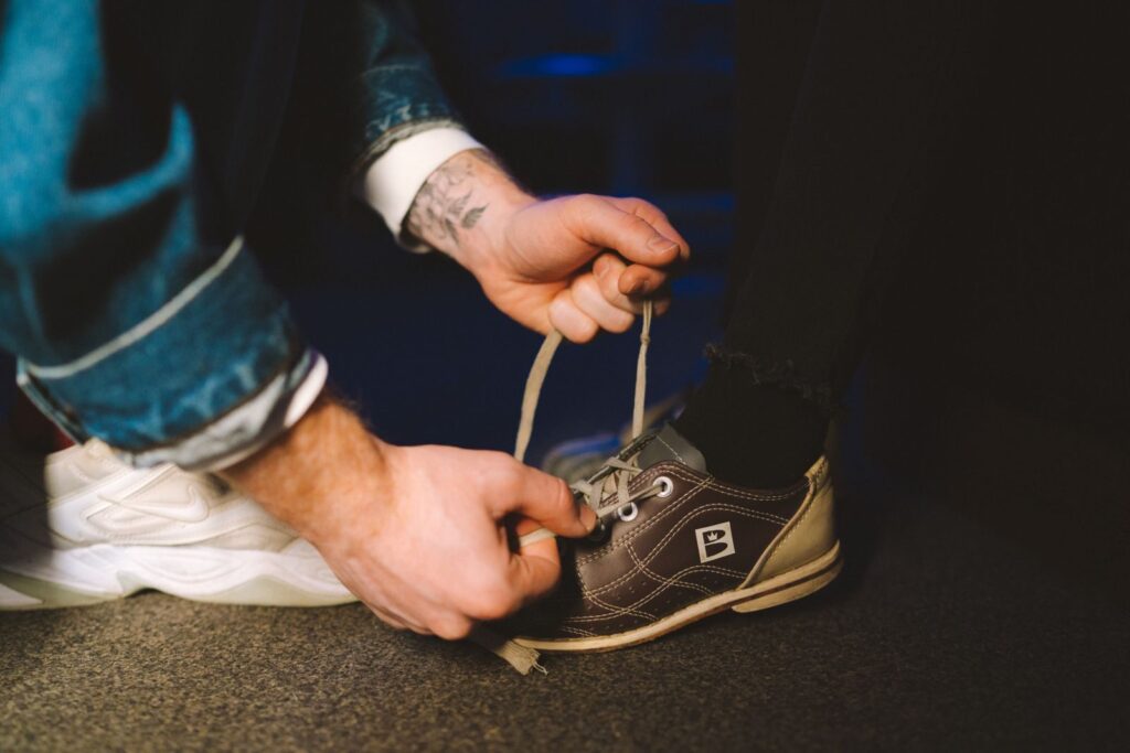 Hands tying a shoelace before a walk